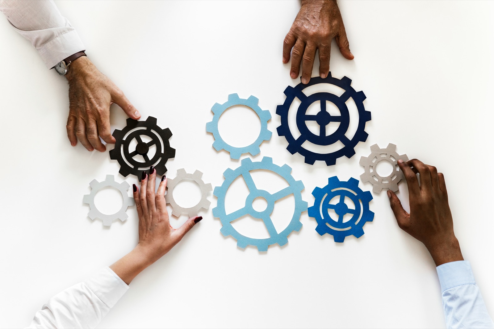 Team arranging interlocking gears together